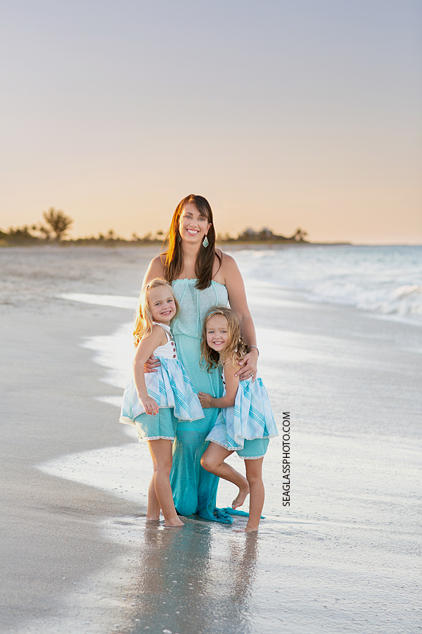Mom and two daughters on the beach during family photos in Vero Beach Florida