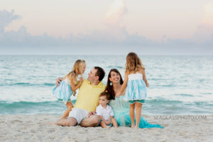 Family starts to settle on the beach during family photos in Vero Beach Florida