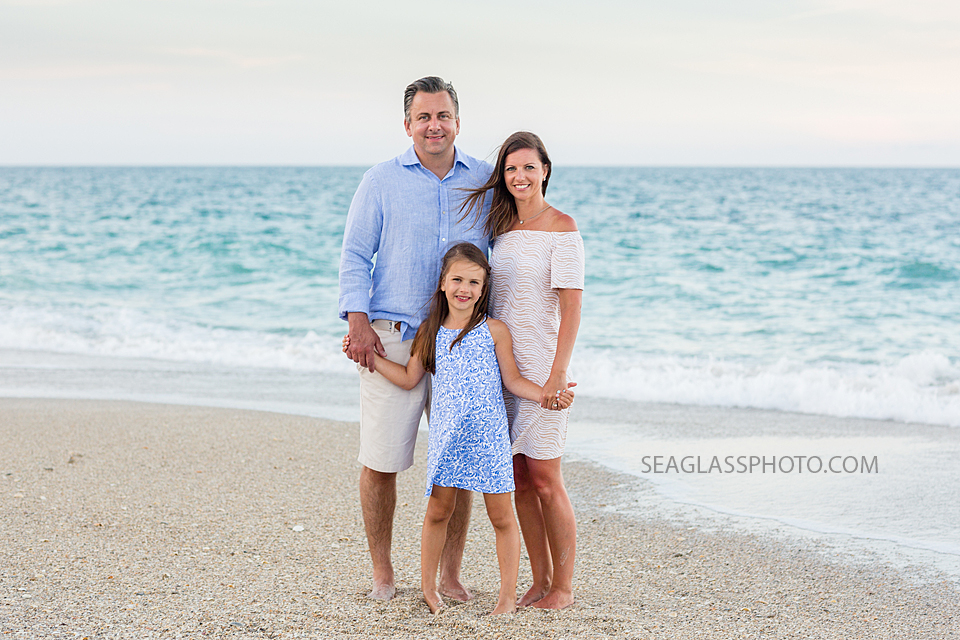 Family smiles on the beach during a family photo shoot in Vero Beach Florida
