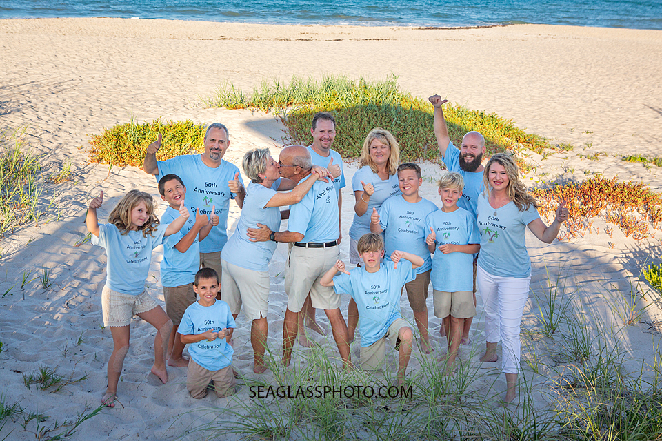 Family put their thumbs up in celebration of their parents/grandparents 50th anniversary in Vero Beach Florida