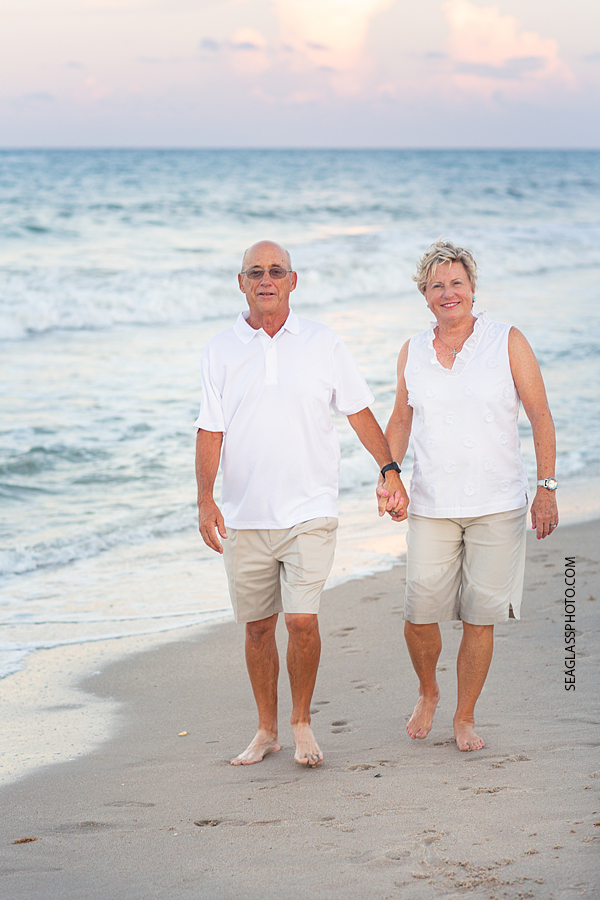 Husband and wife of 50 years walk on the beach during family photo shoot in Vero Beach Florida
