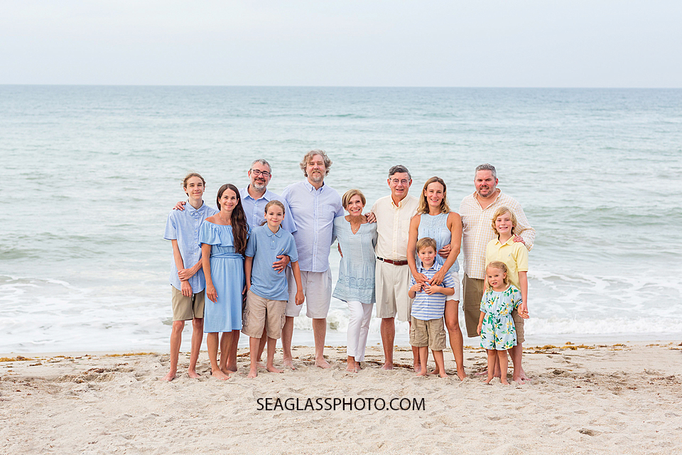 Family gathers on the beach during family photo shoot in Vero Beach Florida