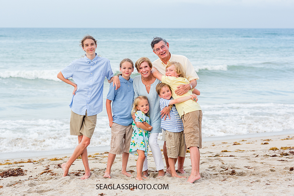 grand kids gather around and hug their grand parents during family photo shoot in Vero Beach Florida