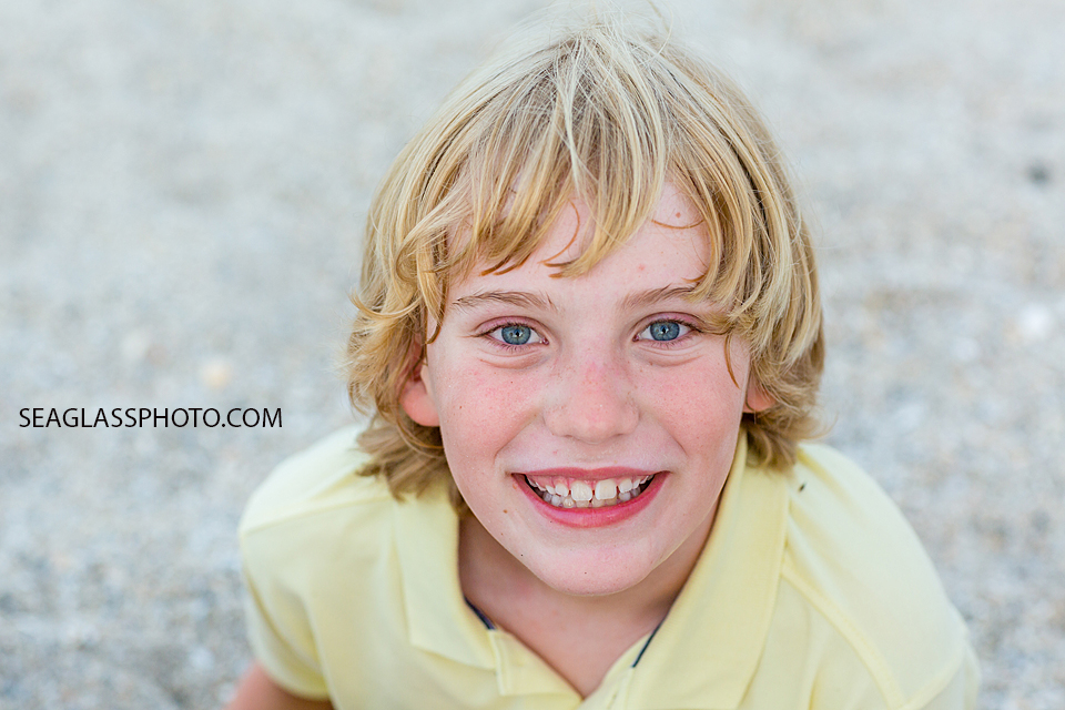 Close up of young boy smiling into the camera during family photo shoot in Vero Beach Florida