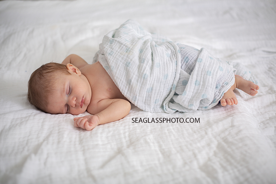 Newborn baby boy sleeps peacefully during newborn session in Downtown Vero Beach Florida