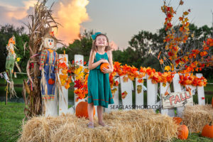 What little girl doesn't love little pumpkins taken by a Vero Beach Florida Photographer