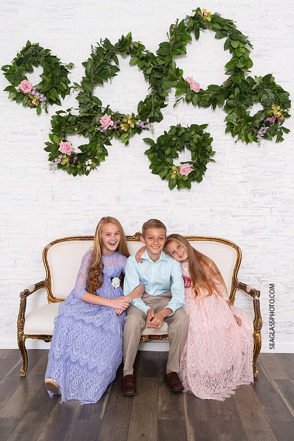 Siblings get close for a picture during family photos in Vero Beach Florida