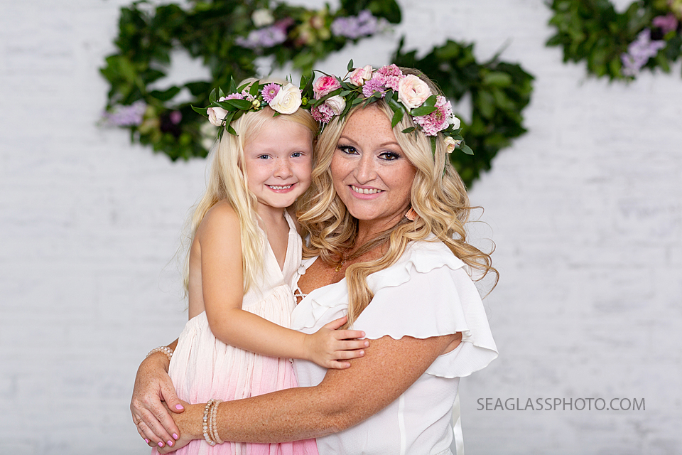 Close up of mom and daughter wearing matching flower crowns during photo shoot in Vero Beach Florida