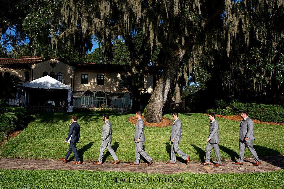 Groom and his groomsmen walk to the alter photographed by a Vero Beach Photographer