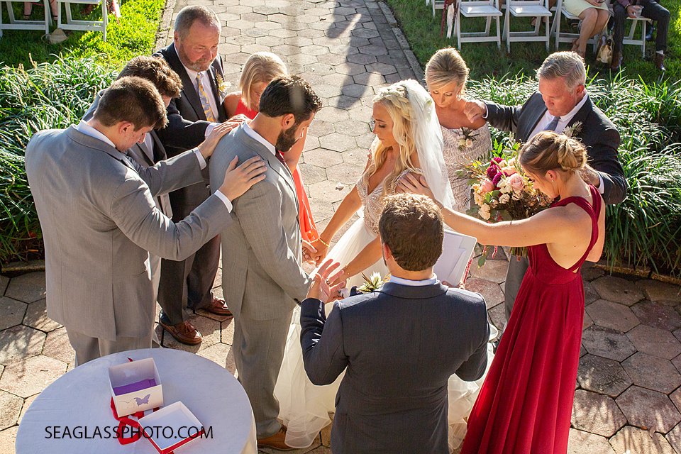 Bride and Groom Praying with their families before the vows photographed by a Vero Beach Photographer