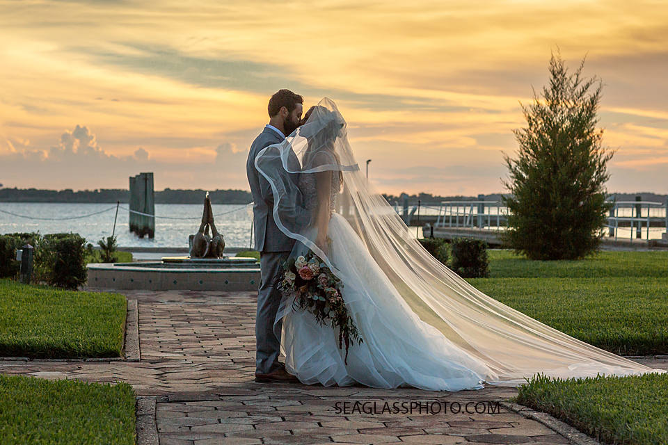 Husband and Wife kiss by the Bay photographed by a Vero Beach Photographer