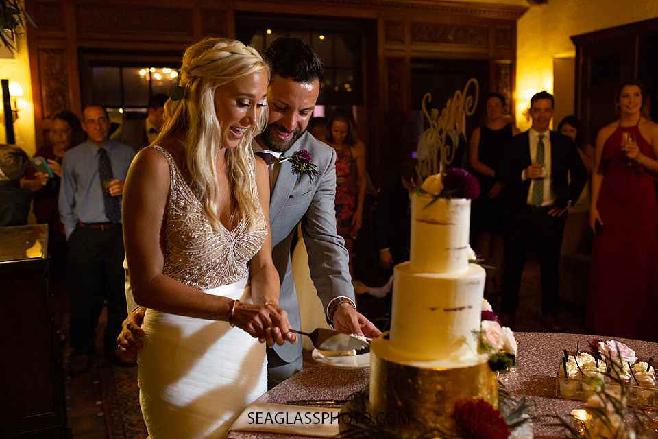 Bride and groom cut the cake at the reception photographed by a Vero Beach Photographer