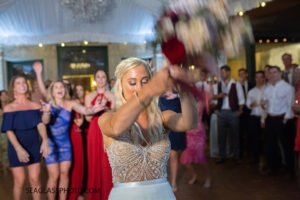 Close up of the Bride tossing her bouquet photographed by a Vero Beach Photographer