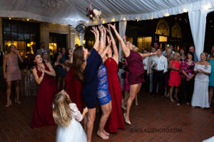 Girls trying to catch the bouquet photographed by a Vero Beach Photographer