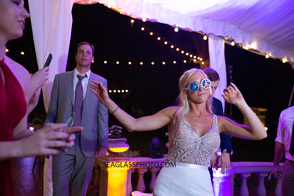 Bride gets funky on the dance floor during the reception photographed by a Vero Beach Photographer