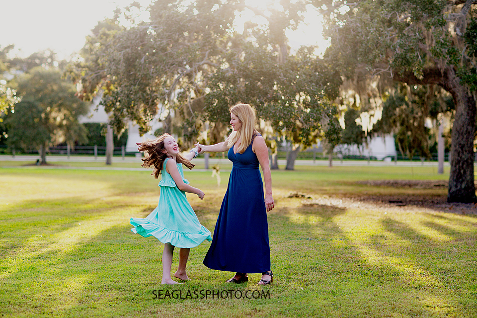 Mother and daughter dancing and laughing together at Riverside Park in Vero Beach Florida