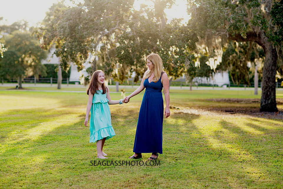 Mother and daughter walking in the grass at Riverside Park in Vero Beach Florida