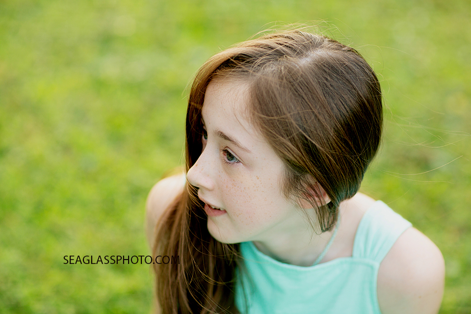 Close up of young girl looking off into the distance at Riverside Park in Vero Beach Florida