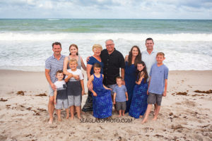 Family gathers for pictures on the beach during family photos in Vero Beach Florida