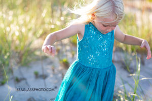 Close up of a young girl walking in the duns on the beach during family photos in Vero Beach Florida