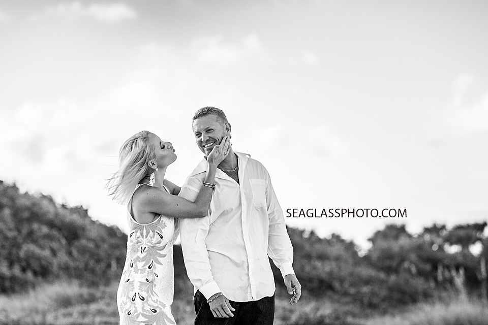 Black and white photo of husband and wife on the beach during family photos in Vero Beach Florida