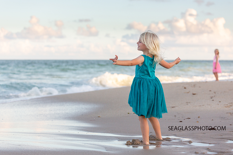 Young girl takes in the beauty of the sea during family photos in Vero Beach Florida