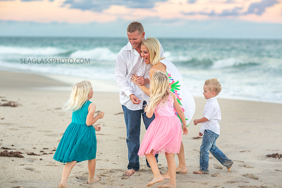 family plays on the beach during family photos in Vero Beach Florida