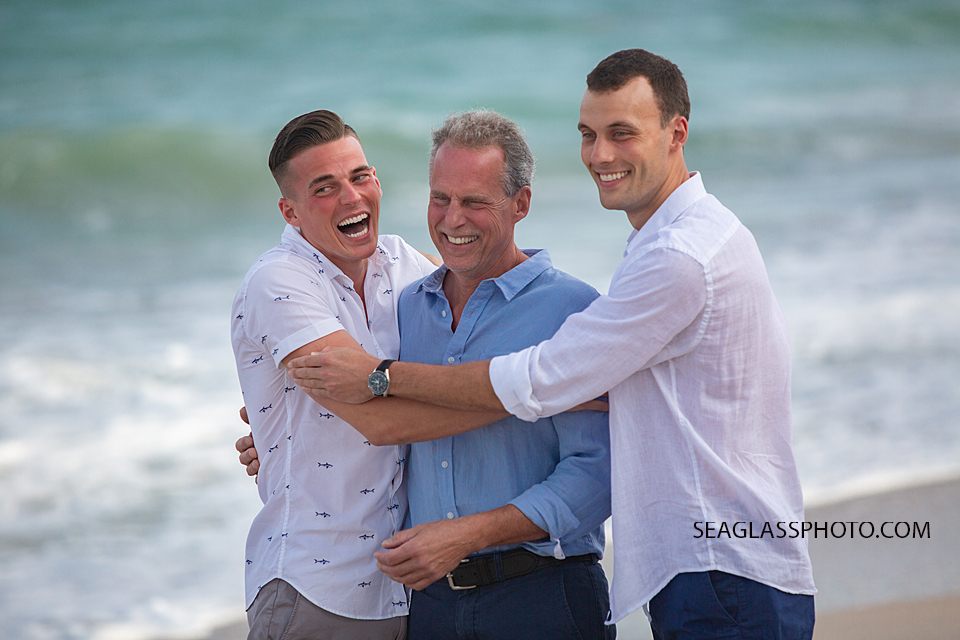 Sons mess with their father during family photos in Vero Beach Florida