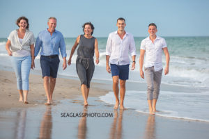 Family walks on the beach during family photos in Vero Beach Florida