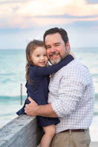 Close up of Father and daughter on the boardwalk during family photos in Vero Beach Florida