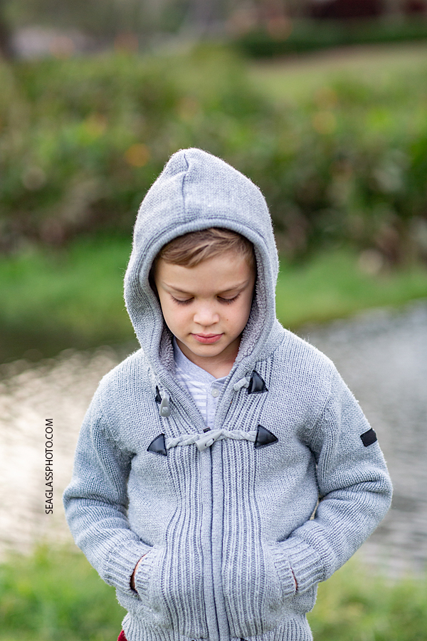 Close up of young boy looking cool in his winter jacket during family photos at the Country Club in Vero Beach Florida