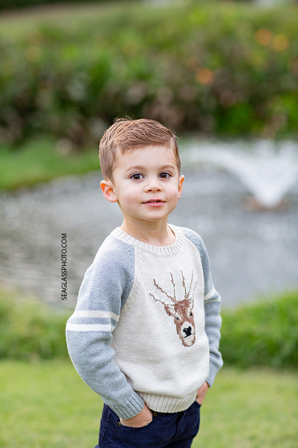 Close up of young boy smiling for the camera during family photos at the Country Club in Vero Beach Florida