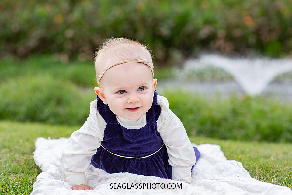 Baby girl starting to crawl during family photos at the Country Club in Vero Beach Florida