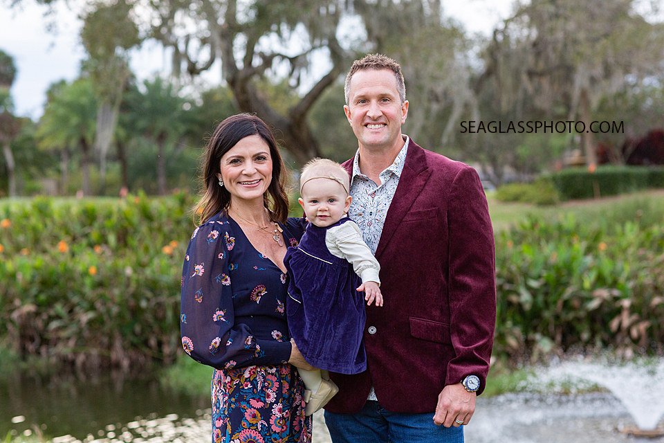 Close up of parents holding their daughter during family photos at the Country Club in Vero Beach Florida
