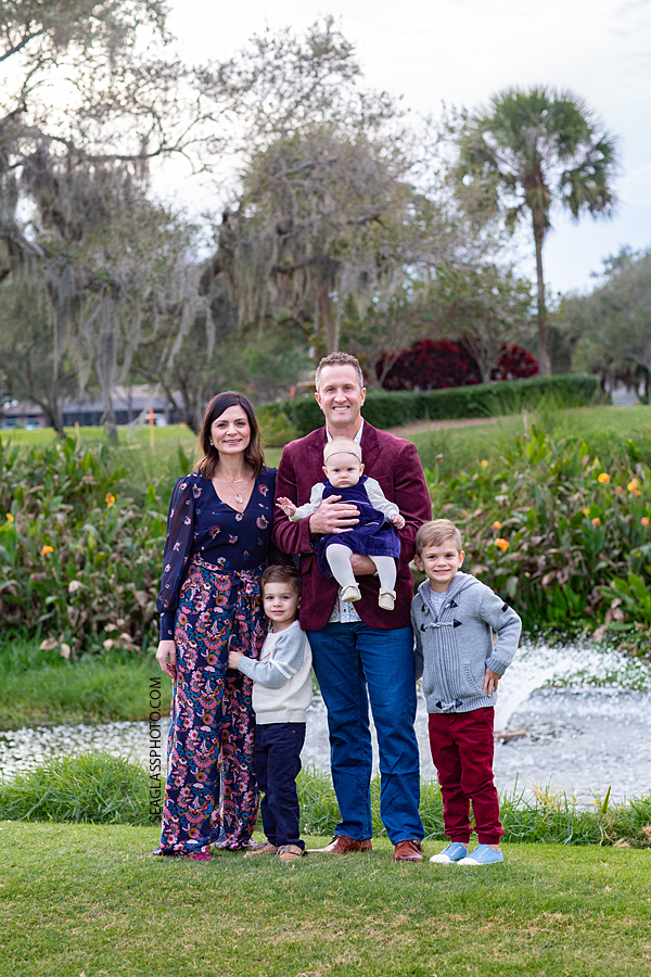 Family of five hug together during family photos at the Country Club in Vero Beach Florida