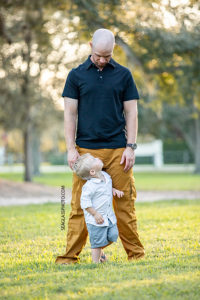 Father and son look at each other during family photos at Riverside in Vero Beach Florida