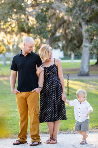 Family smiles as they walk during family photos at Riverside in Vero Beach Florida