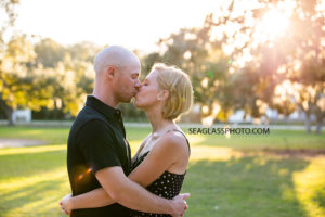 Couple kisses during family photos at Riverside in Vero Beach Florida