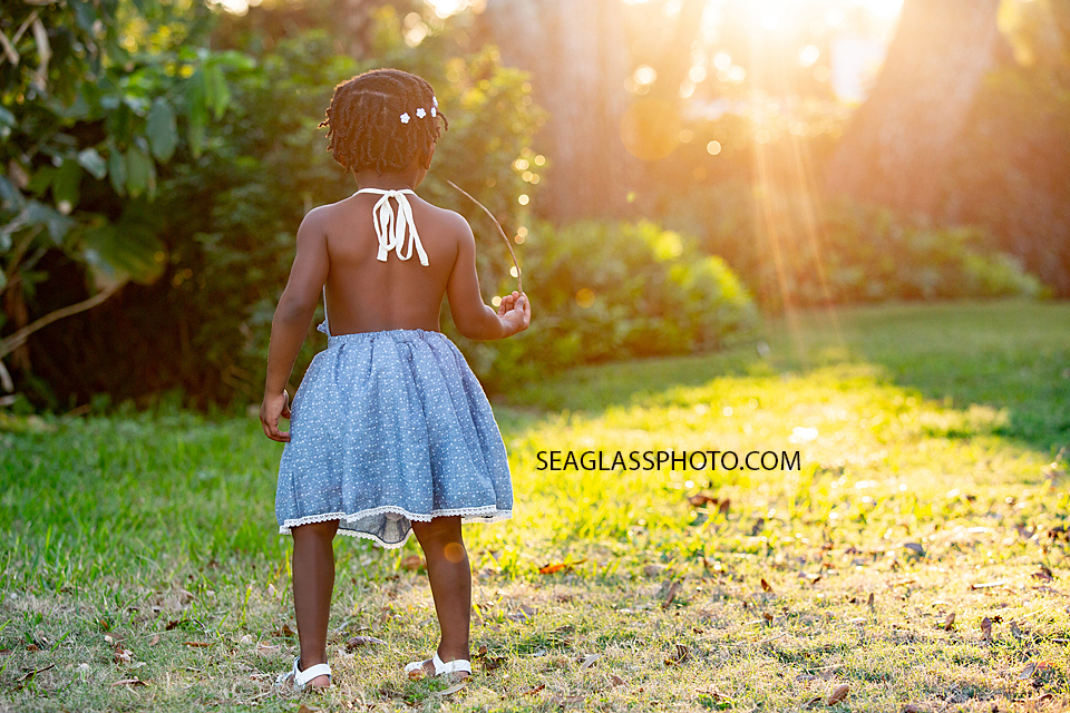 Little girl wondering around the garden during family photos in Vero Beach Florida