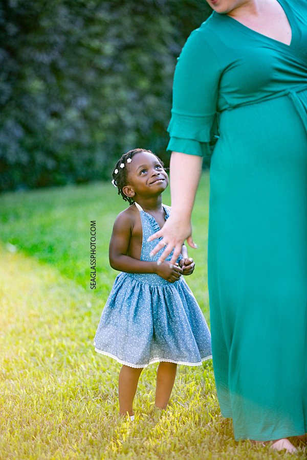 Little girl looking up at her mom during family photos in Vero Beach Florida