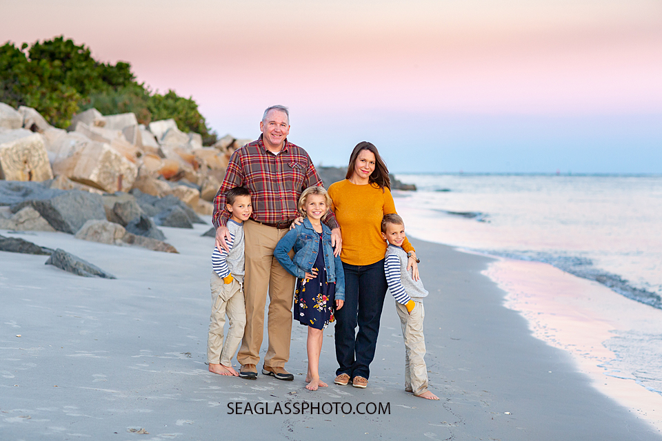 Family smiles for a photo at the Fort Pierce Inlet during family photos