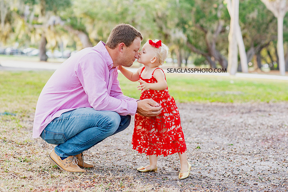 Daughter kisses her dad on the nose during family photos at Riverside in Vero Beach Florida
