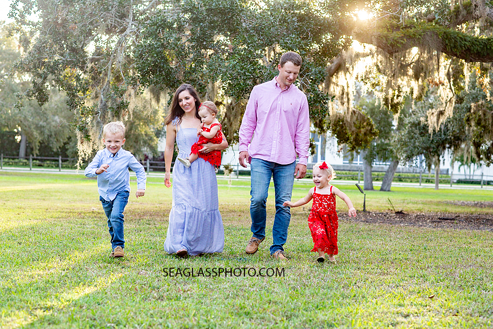 Family walks together during family photos at Riverside in Vero Beach Florida
