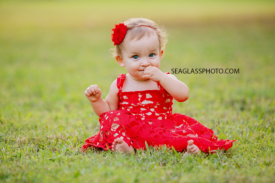 Close up of young girl sitting in the grass during family photos at Riverside in Vero Beach Florida