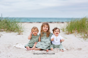 Cousins sit on the beach during family photos in Vero Beach Florida