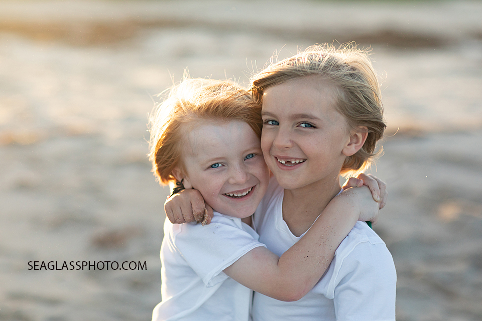 Close up of brothers hugging on the beach during family photoshoot in Vero Beach Florida