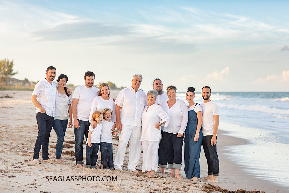 Family in white and navy together on the beach during family photoshoot in Vero Beach Florida