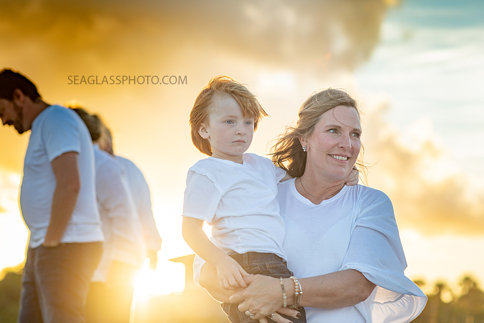Mother holds her son while admire the beauty around them during family photoshoot in Vero Beach Florida