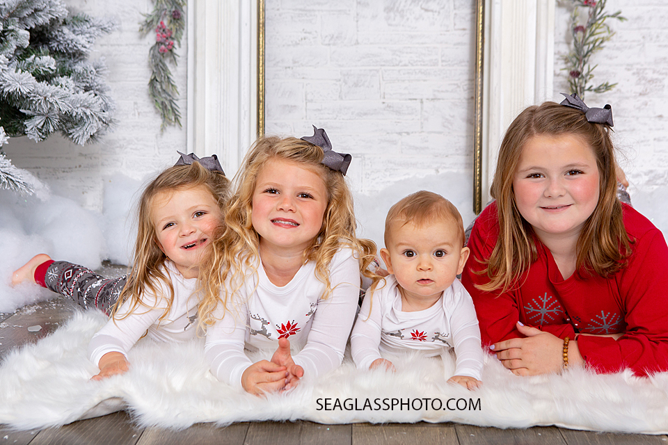 Close up of four siblings laying together during family photos in Vero Beach Florida