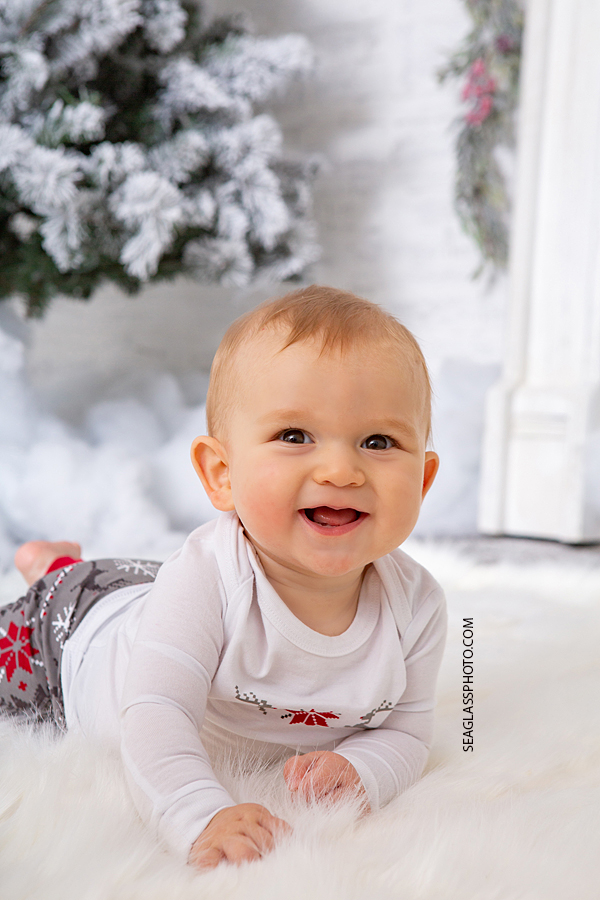 Close up of baby oy smiling for his first Christmas during holiday family photos in Vero Beach Florida